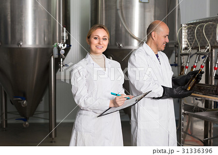 Two workers on brewery factory. 31336396