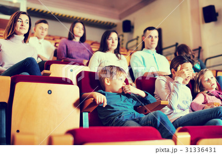 Group of people watching movie attentively 31336431