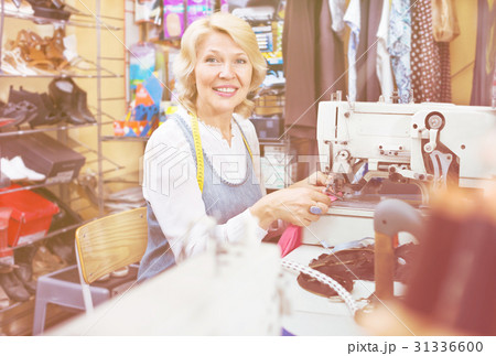 Female tailor working on sewing machine Female tailor working on sewing machine 31336600