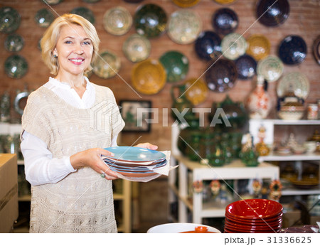 Woman posing with ceramic tableware 31336625