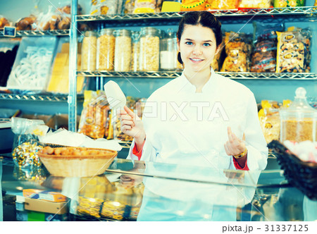 Shopgirl sells useful nuts and dried fruits 31337125