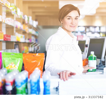 Pharmacist ready to assist in choosing at counter 31337382