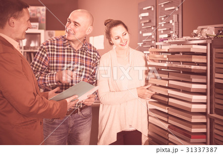 shop assistant working with cheerful customer in store 31337387