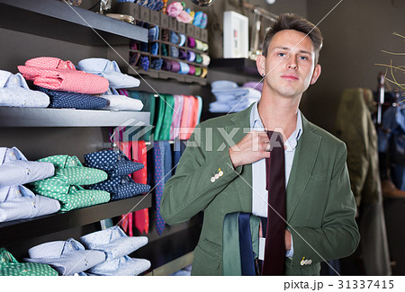 Ordinary guy choosing new tie Ordinary guy choosing new tie 31337415