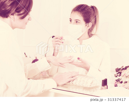 Woman doing shellac manicure Woman doing shellac manicure 31337417