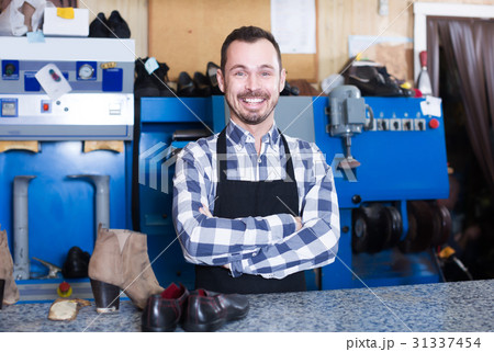 Positive worker showing his workplace and tools 31337454