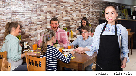Young waitress with menu is inviting 31337516