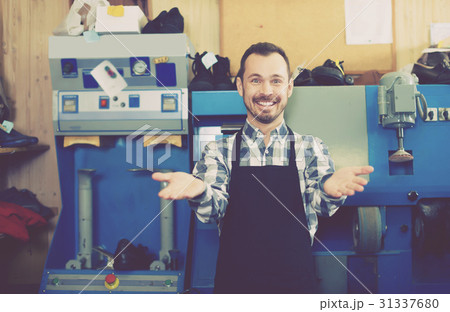 Adult worker showing his workplace and tools Adult worker showing his workplace and tools 31337680