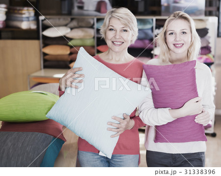 Adult girl and mother enjoying purchased pillows 31338396