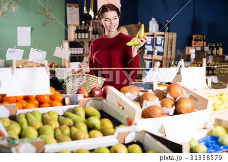 Girl buying ripe pineapple Girl buying ripe pineapple 31338579