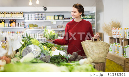 happy young girl buying cauliflower at market happy young girl buying cauliflower at market 31338591