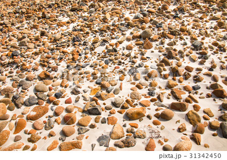 smooth round pebble stones on the sand backgound 31342450