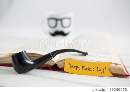 Smoking pipe with happy fathers day text on table Smoking pipe with happy fathers day text on table 31349976
