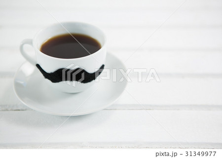 Coffee cup with mustache on white table Coffee cup with mustache on white table 31349977