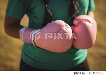 Mid section of woman wearing boxing glove  31354889