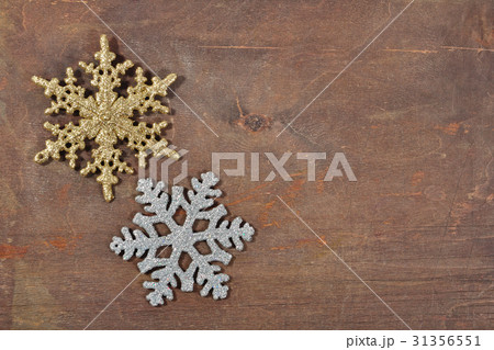 Two snowflakes on a wooden background Two snowflakes on a wooden background 31356551