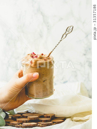 Woman holding in hand jar of chocolate icecream 31357186