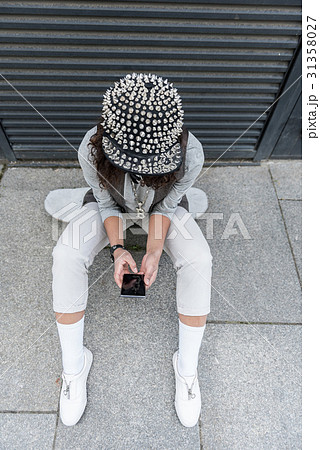 Stylish teenager girl is using phone 31358027