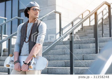 Confident stylish teen is leaning on handrails 31358248