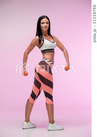 The woman training against pink studio 31358766