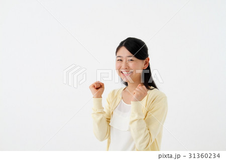 両手でガッツポーズをしている女性の写真素材