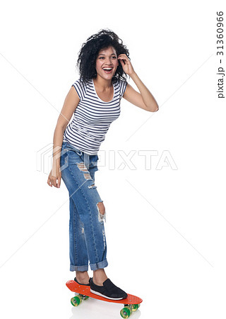 Happy female in distressed jeans with skateboard Happy female in distressed jeans with skateboard 31360966