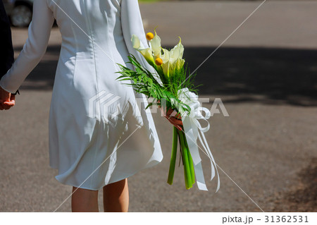girl in white dress with a bouquet of flowers girl in white dress with a bouquet of flowers 31362531