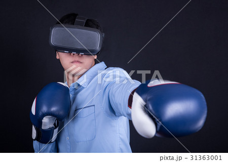 man with virtual reality goggles and boxing gloves 31363001