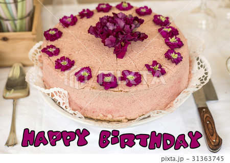Close up cream cake violet flowers on top Close up cream cake violet flowers on top 31363745
