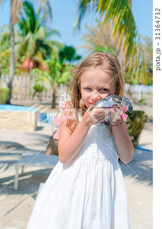 Adorable little girl with a small turtle in her 31364732