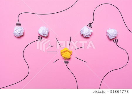 Creative idea of crumpled paper. A burning light bulb on a pink background. Education concept. 31364778