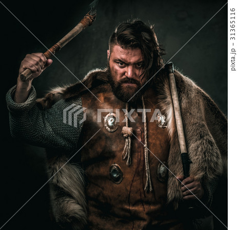 Viking with cold weapon in a traditional warrior Viking with cold weapon in a traditional warrior 31365116
