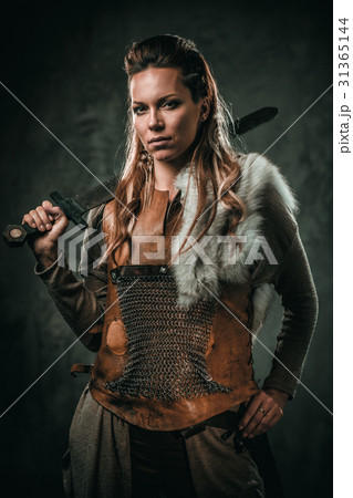 Viking woman with cold weapon in a traditional 31365144