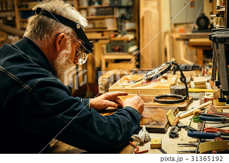 Senior wood carving professional during work 31365192