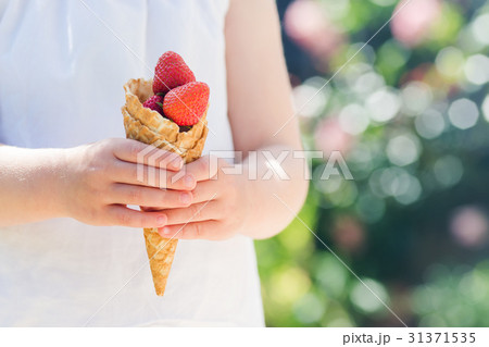 Waffle cone filled with strawberries 31371535