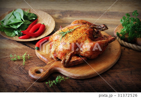 Whole roasted chicken on cutting board. Vintage 31372526