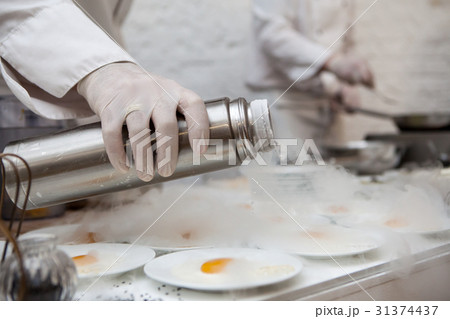 Chef is cooking ice cream with liquid nitrogen Chef is cooking ice cream with liquid nitrogen 31374437