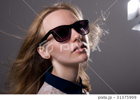 close-up portrait of a young girl in sunglasses  31375909