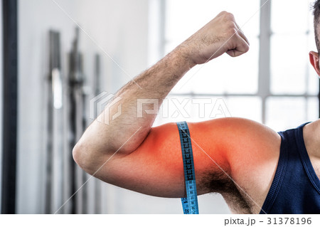 Highlighted arm of man measuring biceps  31378196