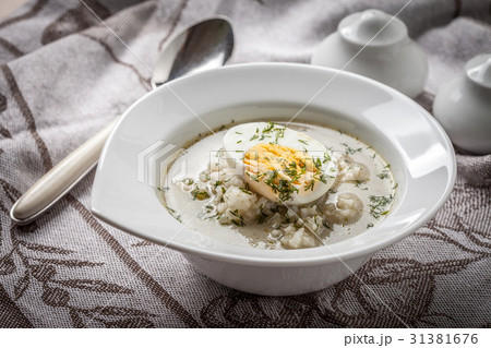 Sorrel soup with egg in white bowl. Sorrel soup with egg in white bowl. 31381676