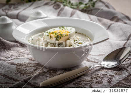 Sorrel soup with egg in white bowl. Sorrel soup with egg in white bowl. 31381677