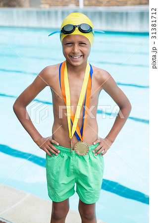 Boy with gold medals around his neck standing Boy with gold medals around his neck standing 31381712