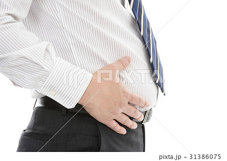 お腹に手をあてるスーツ姿の男性の写真素材