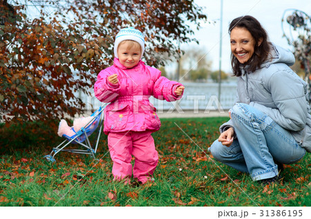 mother and daughter walking in the park 31386195