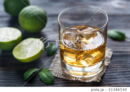 Glass of rum on the wooden background 31386540