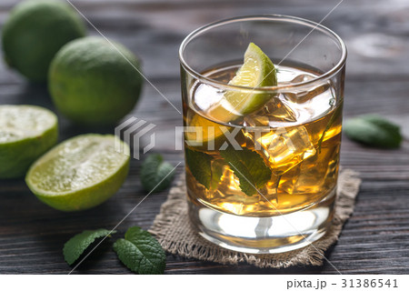 Glass of rum on the wooden background 31386541