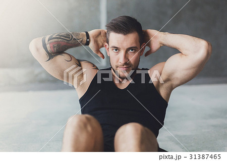 Young man fitness workout, cross crunches for abs Young man fitness workout, cross crunches for abs 31387465