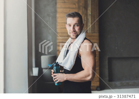 Handsome young man relax at gym after training 31387471