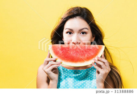 Happy young woman holding watermelon Happy young woman holding watermelon 31388886