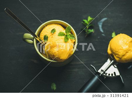 Mango sorbet ice cream scoops with mint, top view 31391421